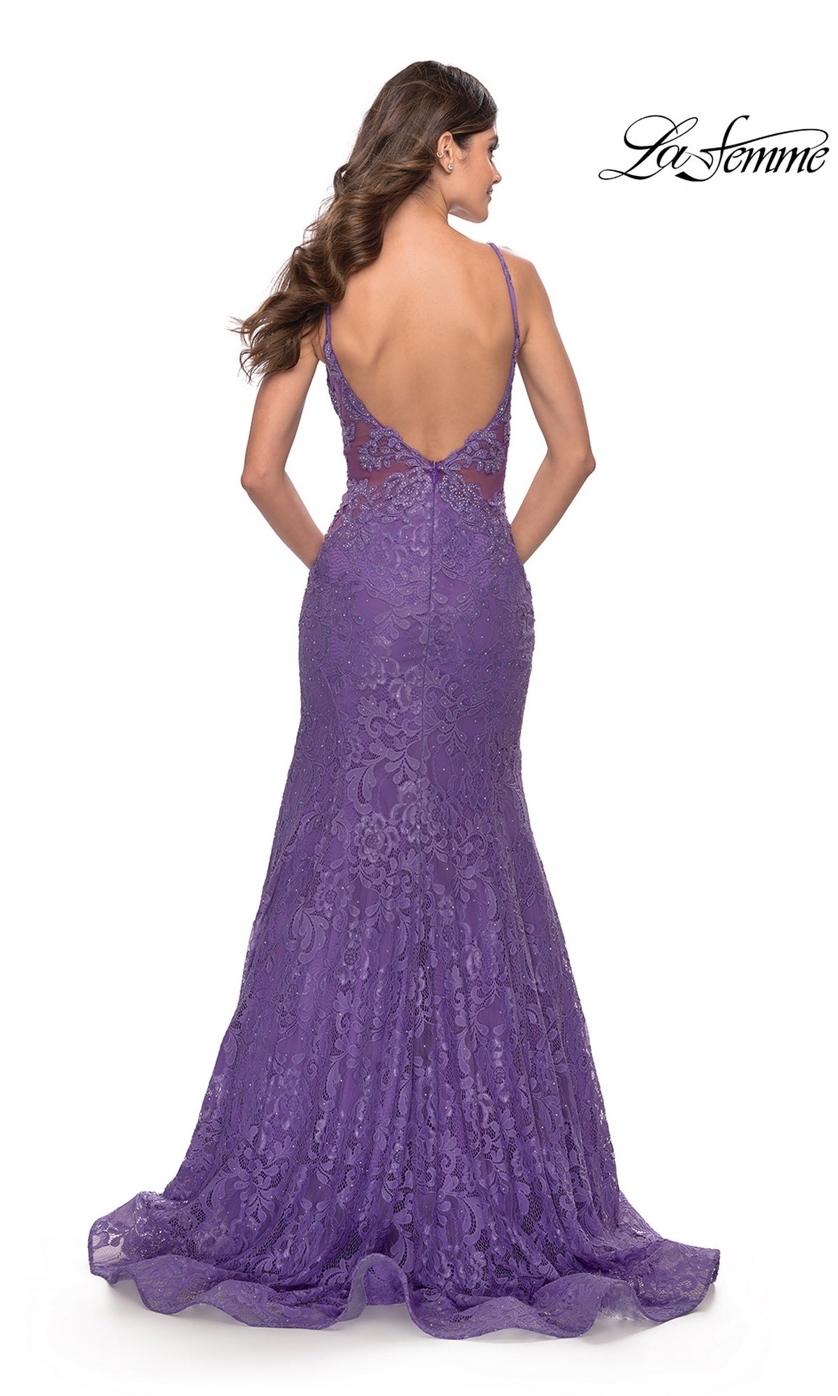 Woman models the Long Lace Mermaid Prom Dress: La Femme 31512, a floor-length purple gown with lace details, deep V-back, and thin straps—an elegant backless style ideal for any special occasion.
